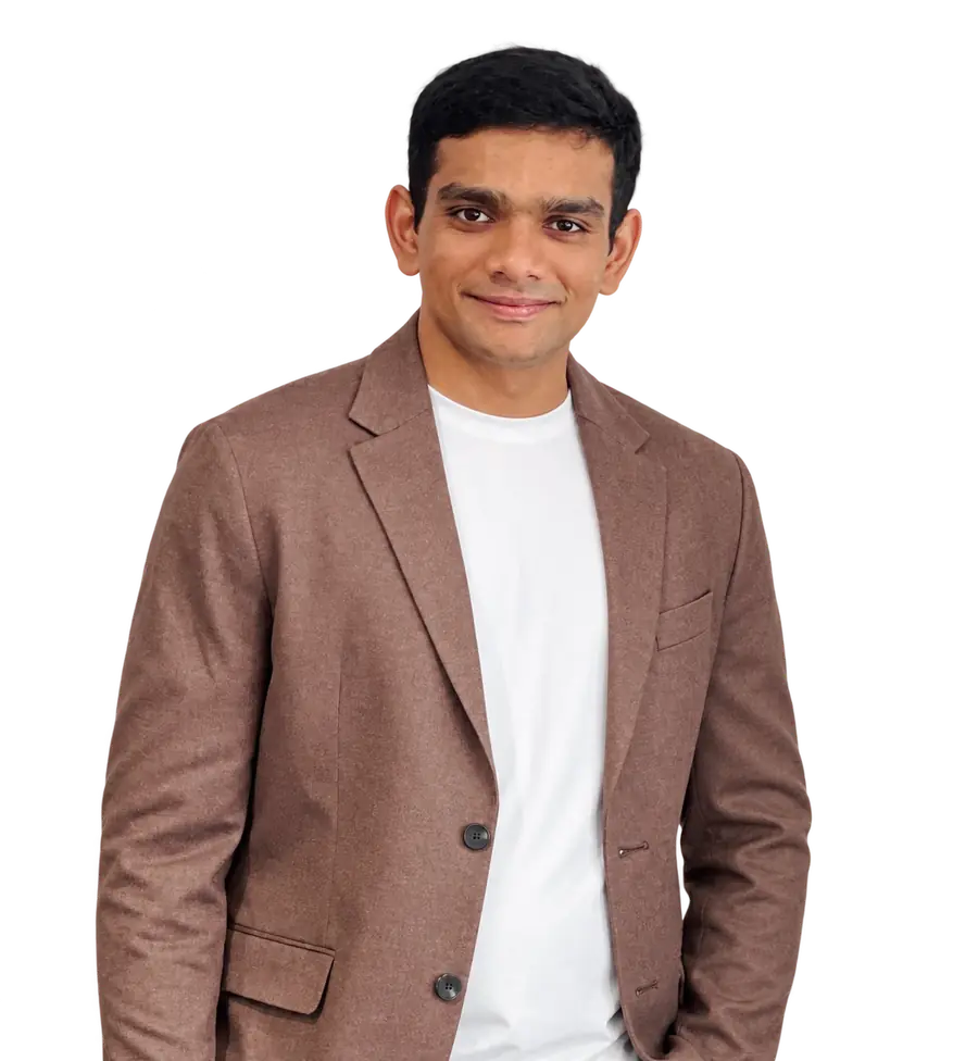 Yeswanth Kanumuri in a brown blazer, smiling